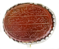 Silvering with a red stone engraved with text